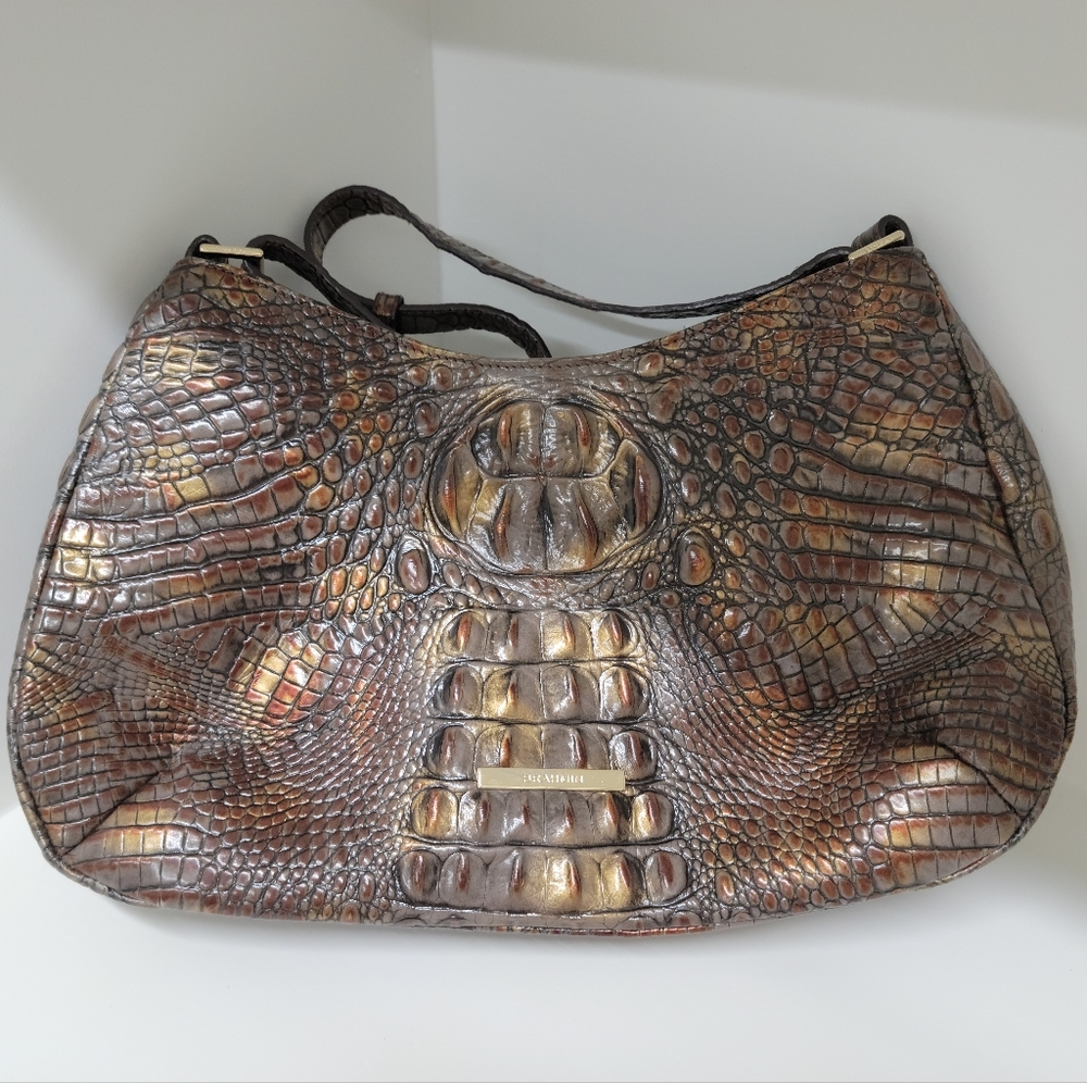 Brahmin lightly used bag, outside has no obvious defects.  Interior is stained.